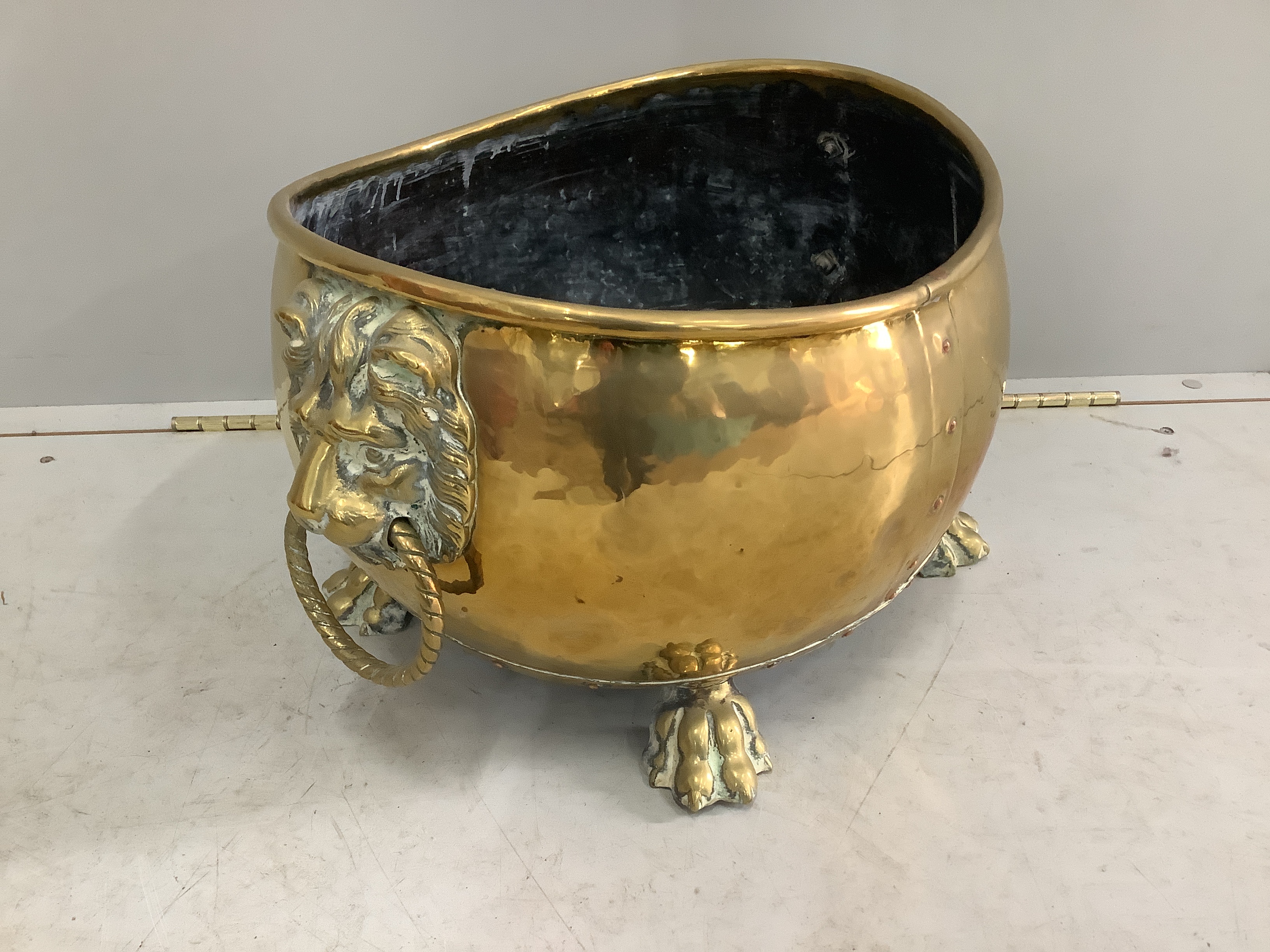 A 19th century Dutch oval and brass coal bin with lion mask ring handles, width 54cm, depth 40cm, height 30cm
